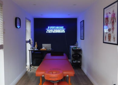 Cozy massage room at JP Sports Massage in Stockport, England, GB with a treatment table and calming decor.