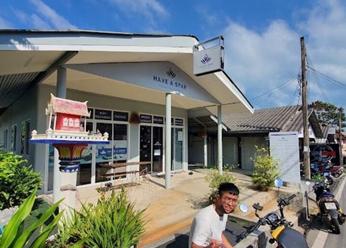 Exterior view of Have A Spar in Surat Thani, featuring lush greenery and traditional decor.