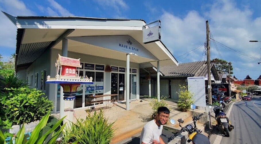 Exterior view of Have A Spar in Surat Thani, featuring lush greenery and traditional decor.