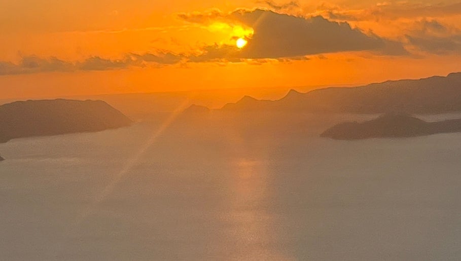 Breathtaking sunset view near Afterglow Skin & Tan, Kerikeri, Northland, NZ showcasing serene waters and mountains.