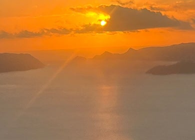 Breathtaking sunset view near Afterglow Skin & Tan, Kerikeri, Northland, NZ showcasing serene waters and mountains.