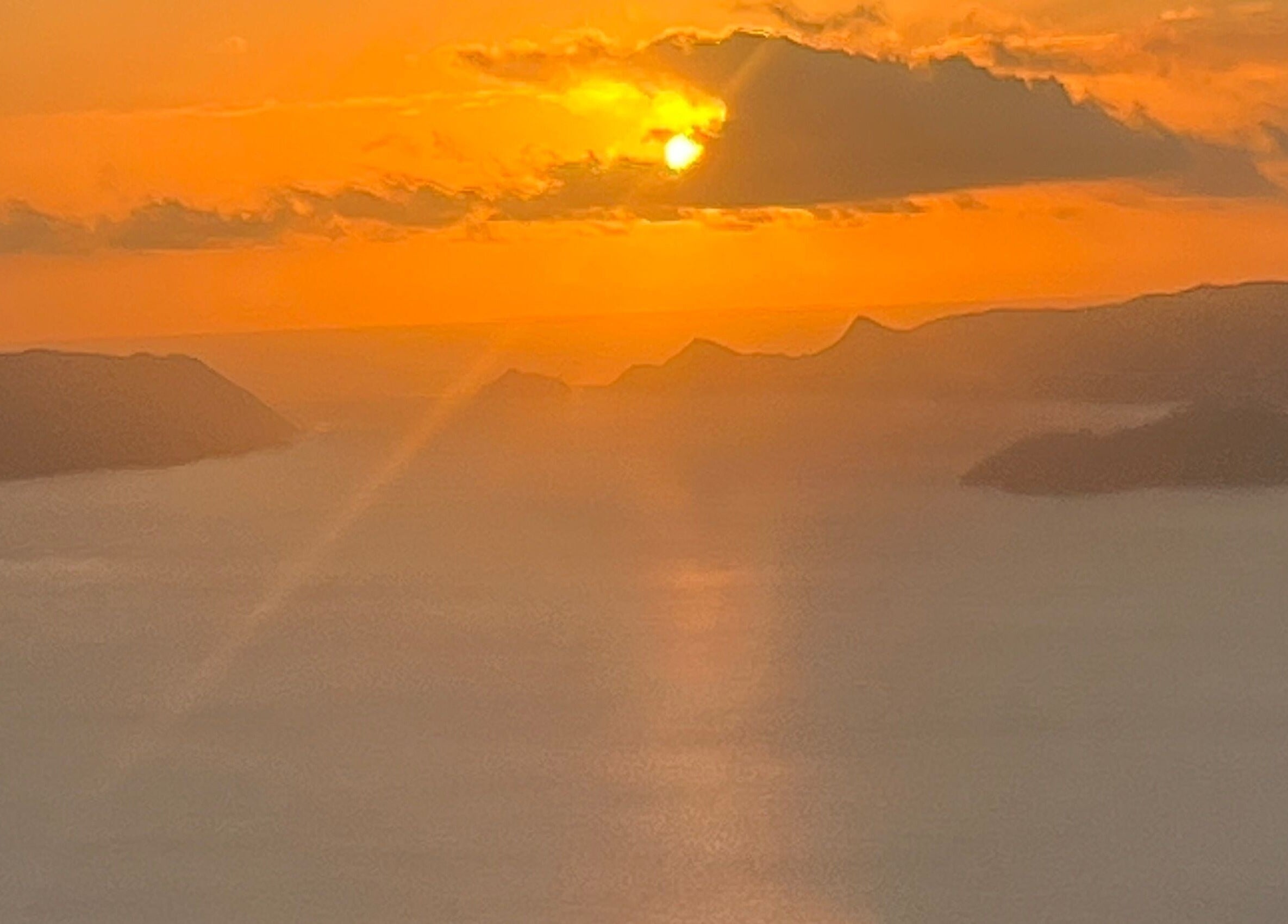 Breathtaking sunset view near Afterglow Skin & Tan, Kerikeri, Northland, NZ showcasing serene waters and mountains.