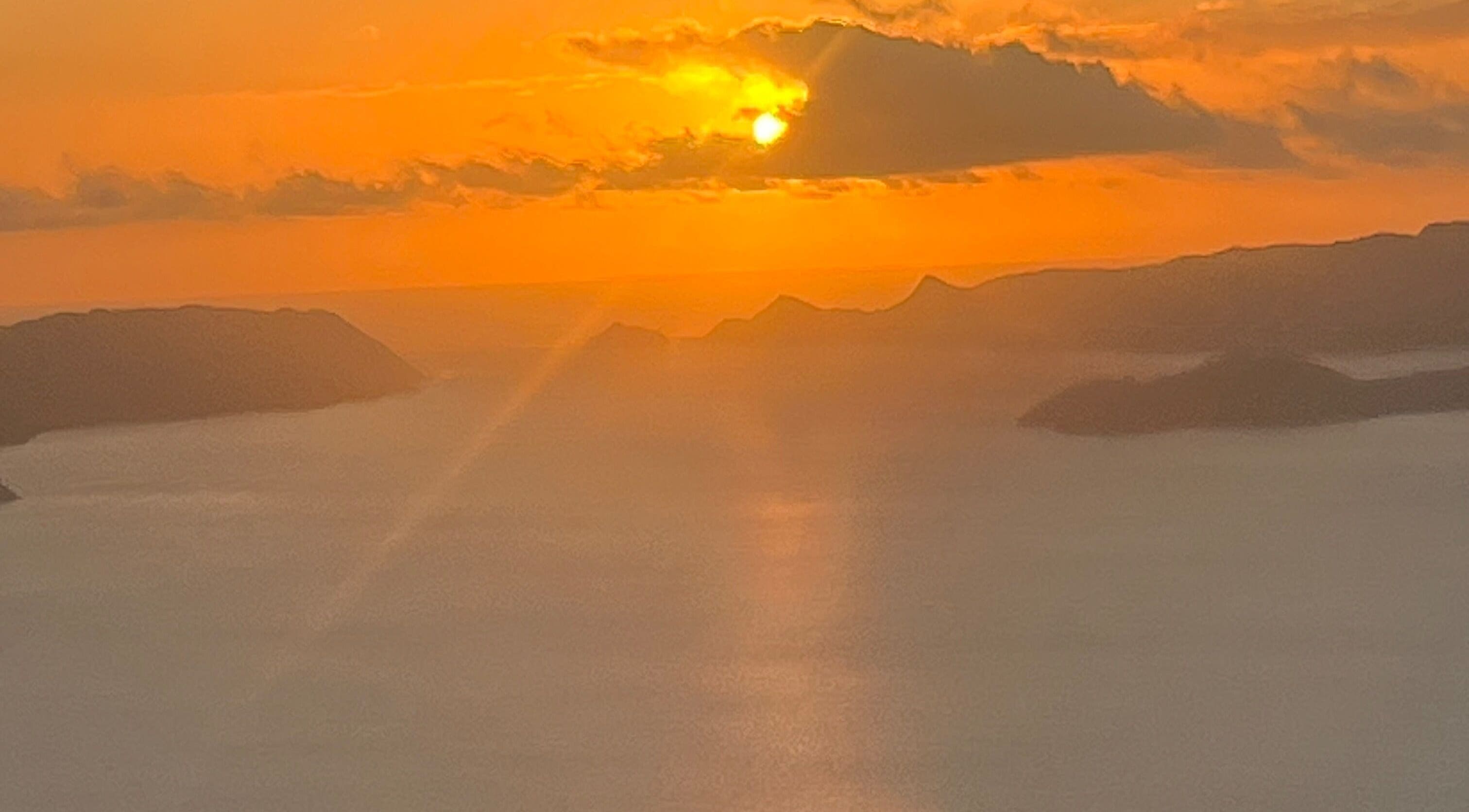 Breathtaking sunset view near Afterglow Skin & Tan, Kerikeri, Northland, NZ showcasing serene waters and mountains.