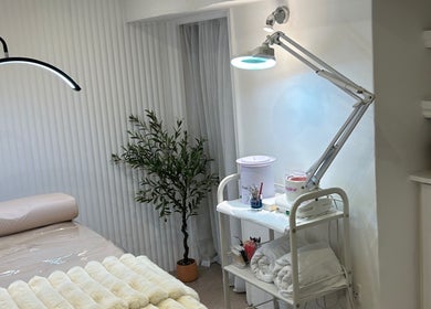 Tranquil beauty treatment room at Houseofbeauty, London, England, GB, showcasing massage table and stylish decor.