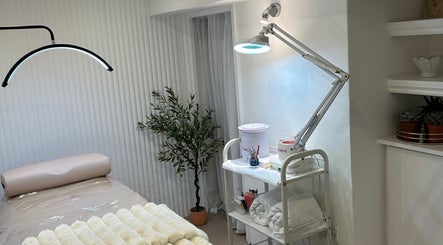 Tranquil beauty treatment room at Houseofbeauty, London, England, GB, showcasing massage table and stylish decor.