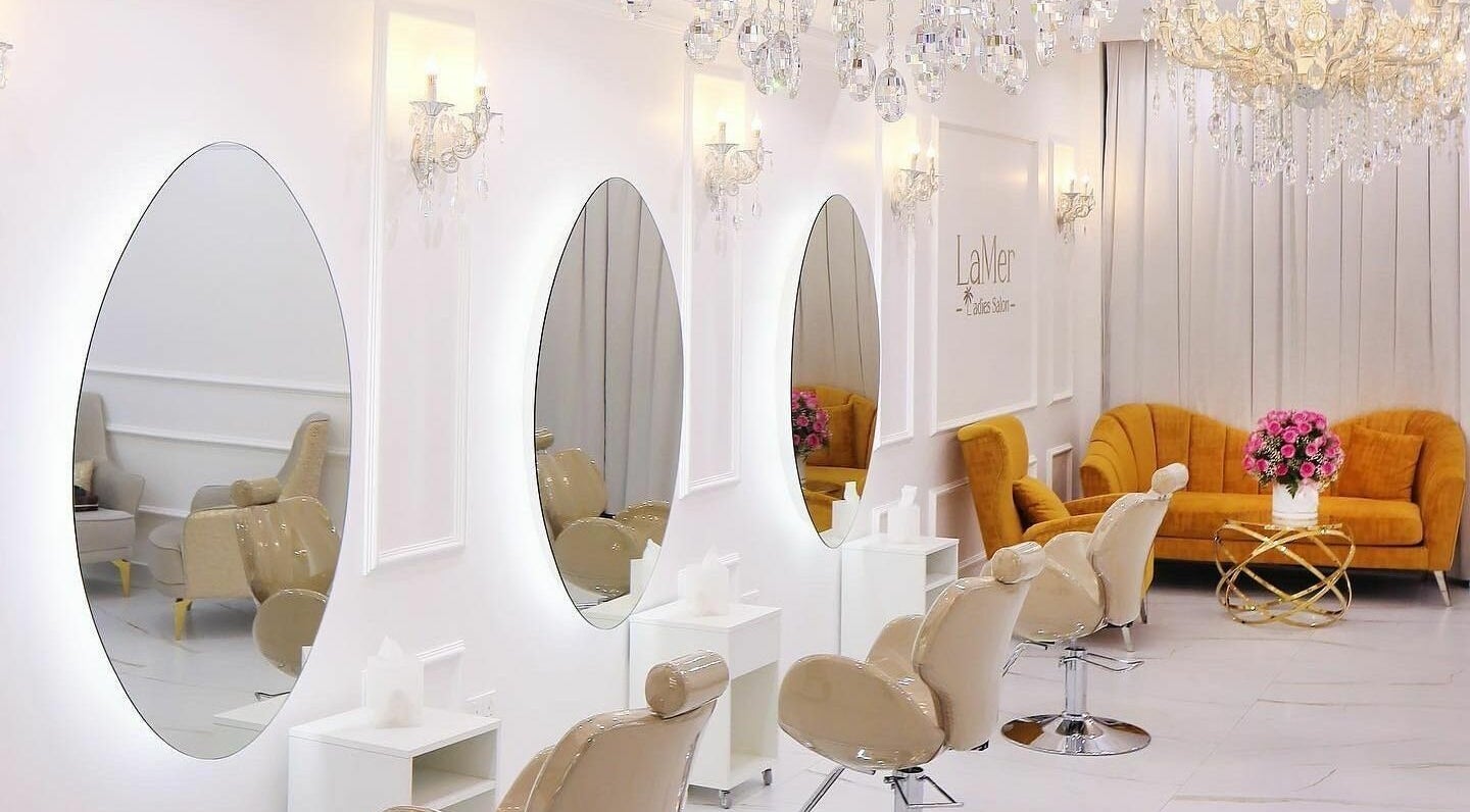 Chic interior of Lamer Ladies Salon in Dubai, Dubai, AE featuring elegant seating and mirrors.