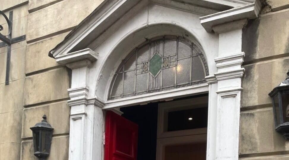 Charming vintage entrance at Nail by Lils, Tamworth, England, GB with a red door and decorative arch.
