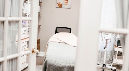 Tranquil treatment room at Pb Beauty Bar in Mooresville, North Carolina, US, showcasing a plush bed and calming decor.