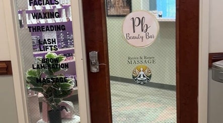 Entrance of Pb Beauty Bar in Mooresville, North Carolina, US, showcasing beauty services like facials, waxing, and massage.