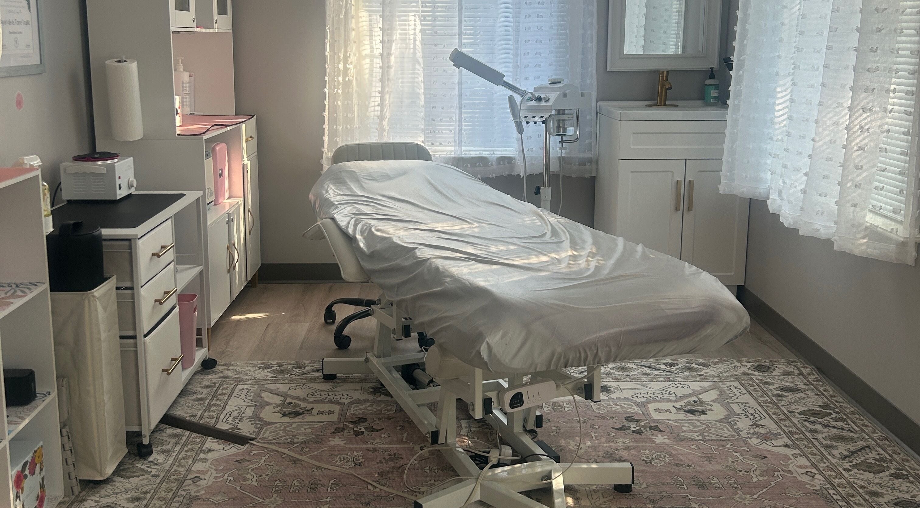 Cozy treatment room at Pb Beauty Bar in Mooresville, North Carolina, US with spa bed and soft lighting.