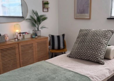 Calon Beauty's tranquil treatment room in Cardiff, Wales, GB, featuring a cozy massage bed with stylish decor.