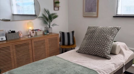 Calon Beauty's tranquil treatment room in Cardiff, Wales, GB, featuring a cozy massage bed with stylish decor.