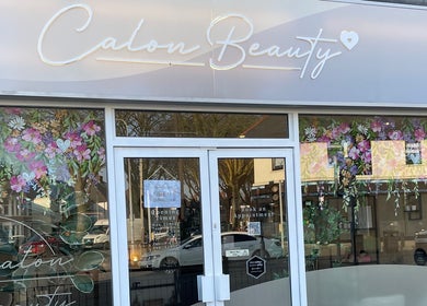 Calon Beauty storefront with floral decor at Cardiff, Wales, GB, inviting for beauty and wellness services.