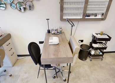 Modern nail station at Calon Beauty, Cardiff, Wales, GB with manicure tools and cozy seating.