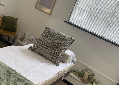 Relaxing treatment room at Calon Beauty, Cardiff, Wales, GB with cozy bed and calming decor.