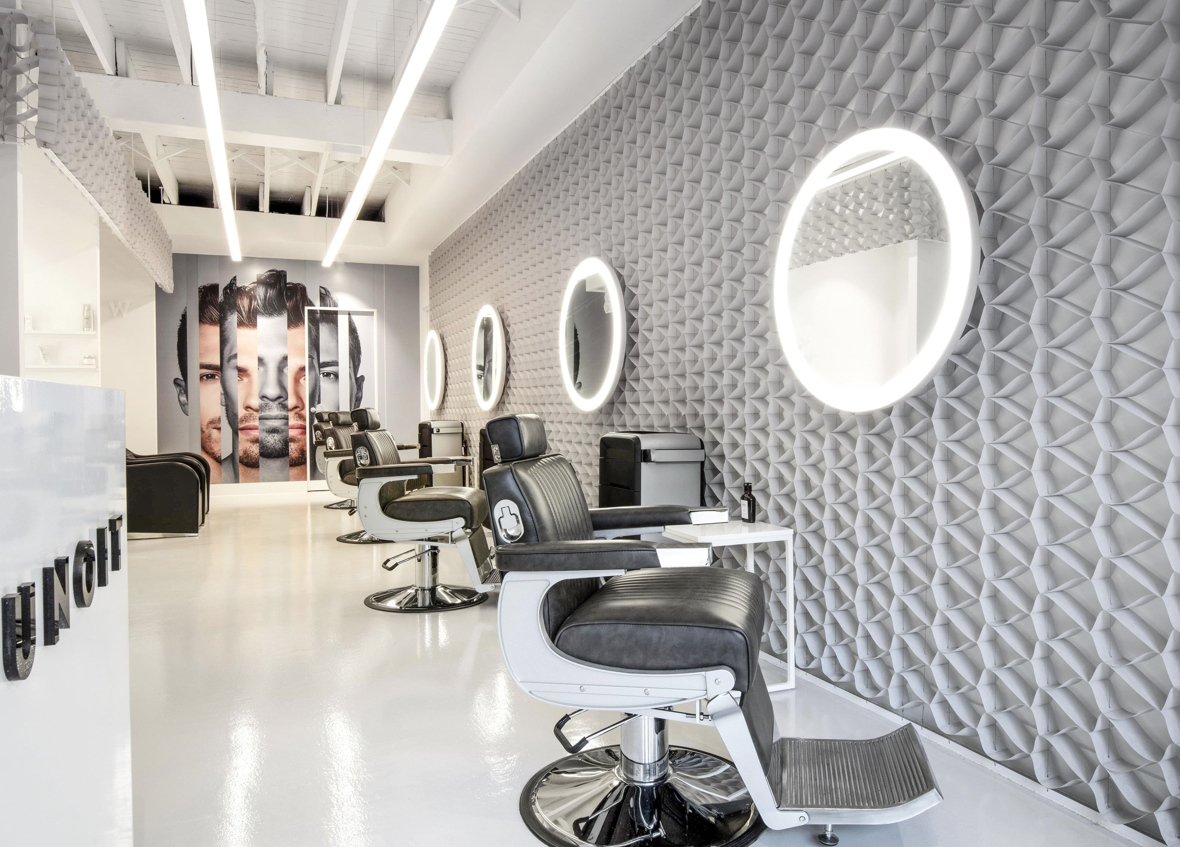 Modern interior of UNOIT Barber in Darlinghurst, New South Wales, AU featuring stylish barber chairs and mirrors.