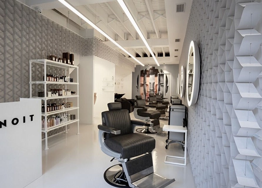 Modern interior of UNOIT Barber in Darlinghurst, New South Wales, AU with stylish chairs and wall decor.