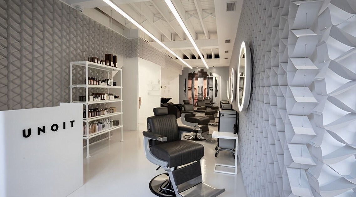 Modern interior of UNOIT Barber in Darlinghurst, New South Wales, AU with stylish chairs and wall decor.