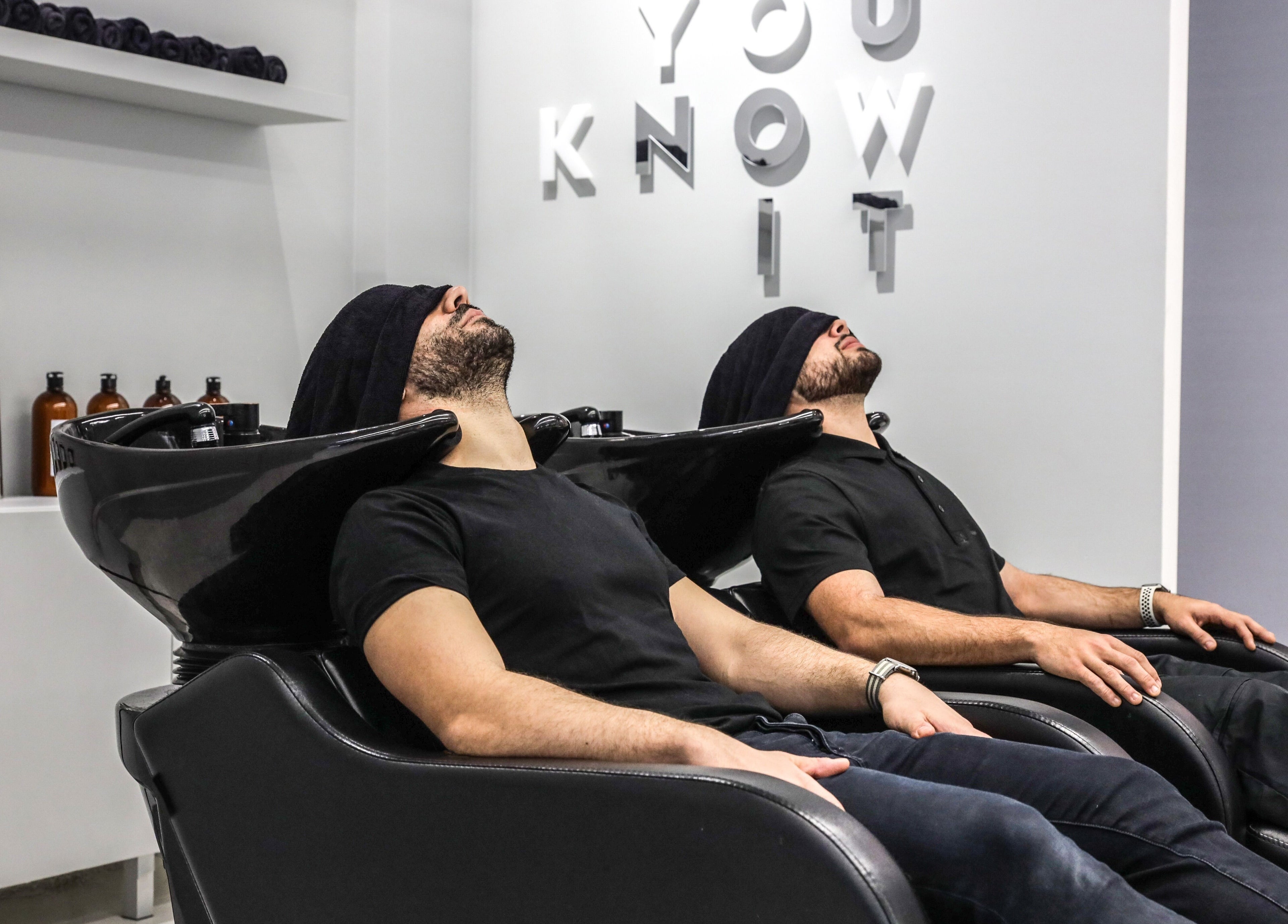 Patrons enjoying a soothing experience at UNOIT Barber, Darlinghurst, New South Wales, AU.