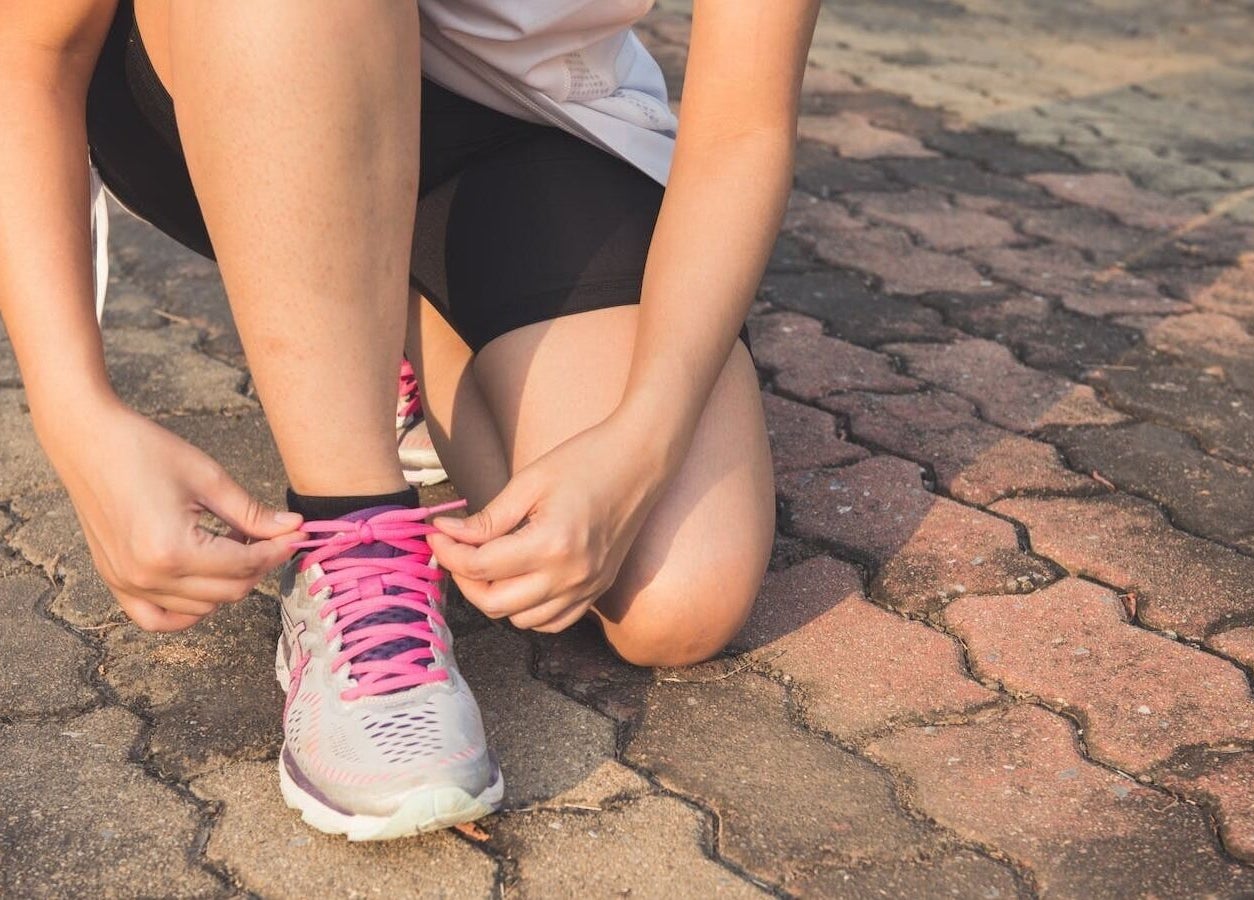 Person tying pink shoelaces at Vixi Wellbeing Hub, Darlington, England, GB.