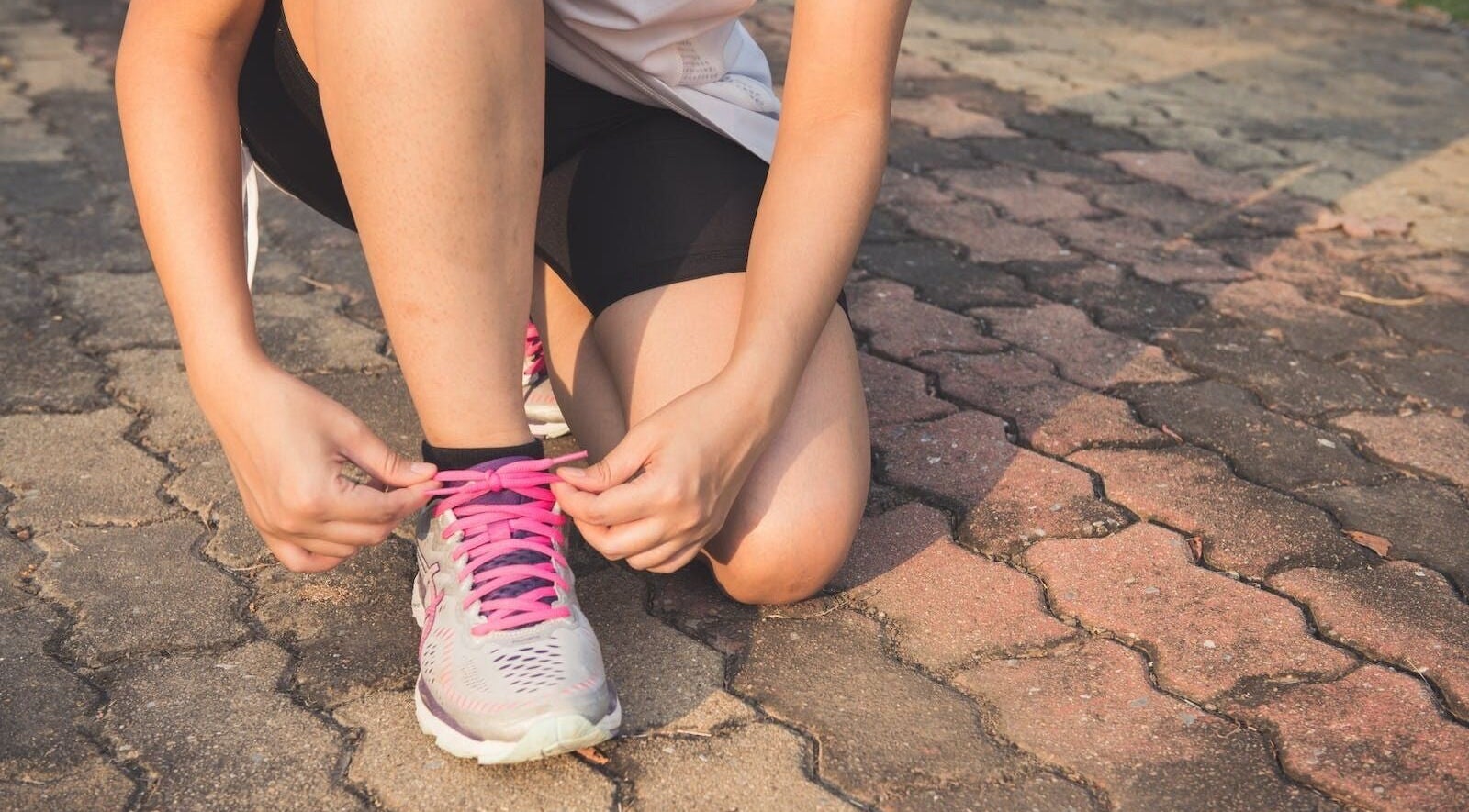 Person tying pink shoelaces at Vixi Wellbeing Hub, Darlington, England, GB.