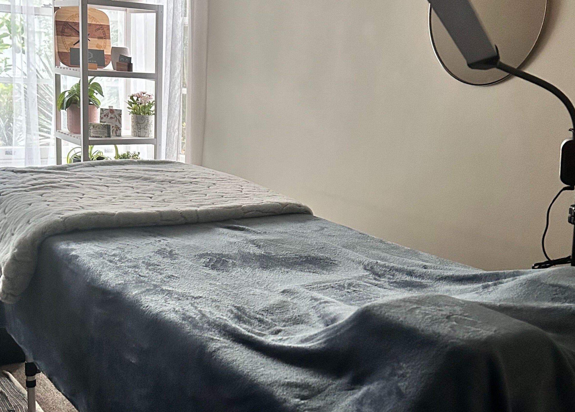 Cozy treatment bed at Glamlash Studio, Mitcham, South Australia, AU, set for beauty therapy session.