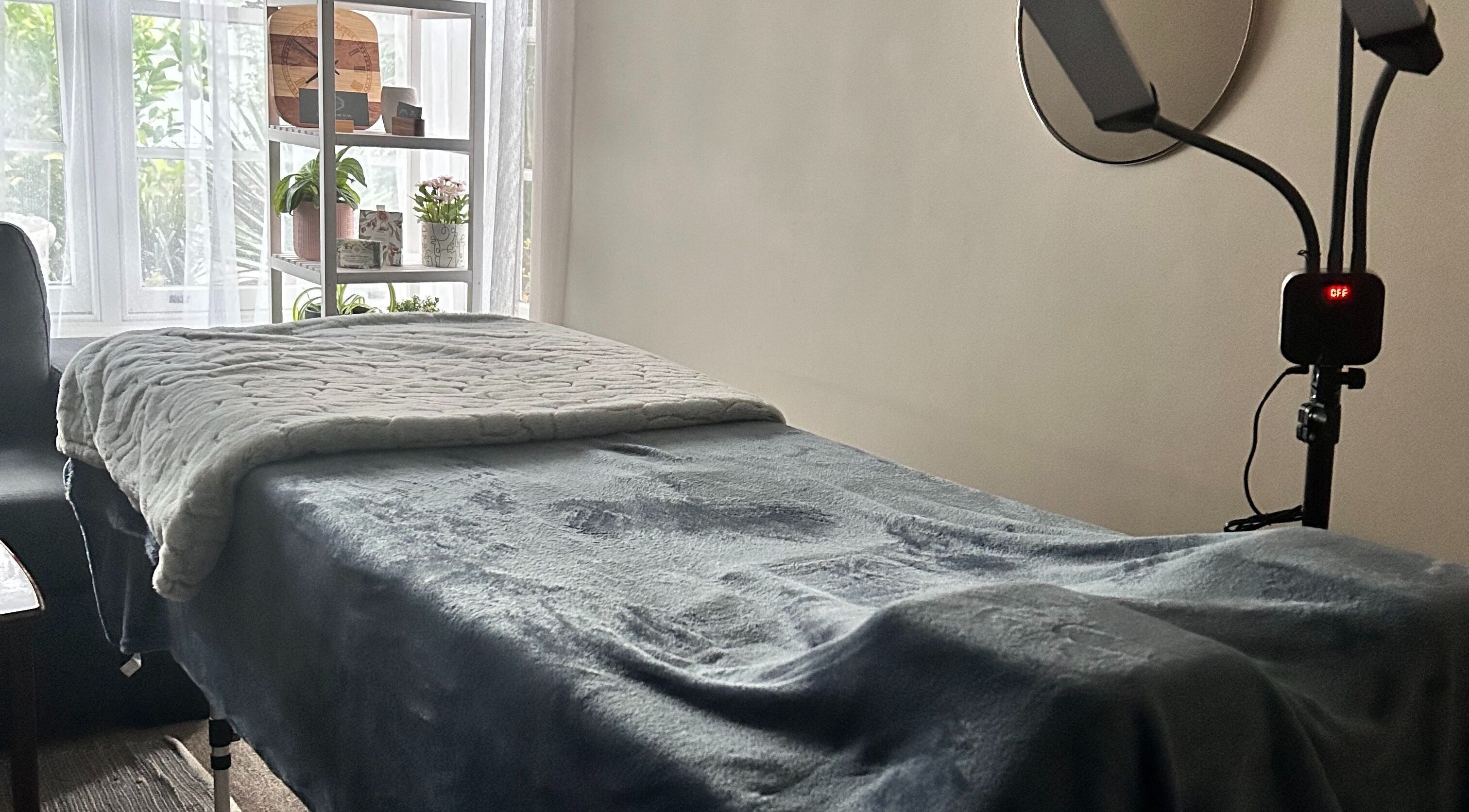 Cozy treatment bed at Glamlash Studio, Mitcham, South Australia, AU, set for beauty therapy session.