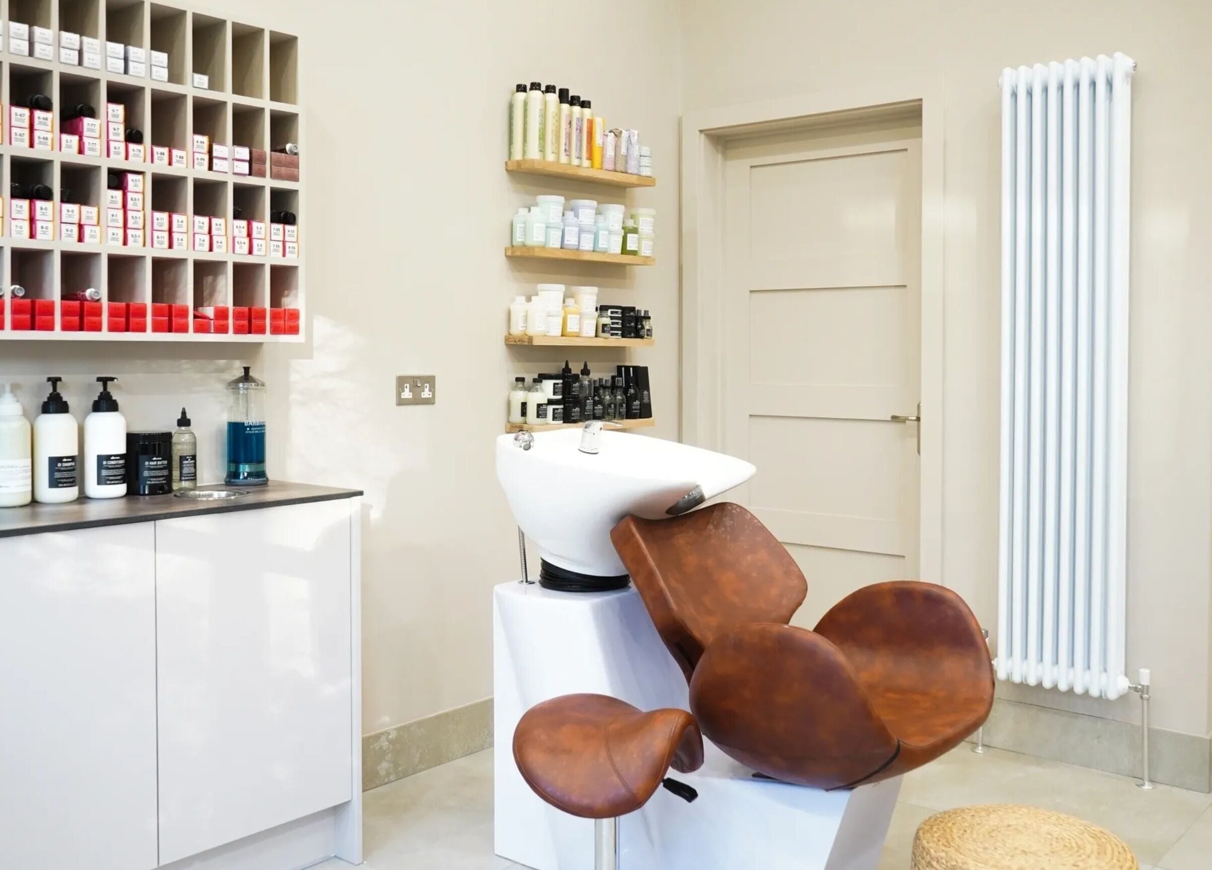 Grace Waker Hair salon interior in Oakley, England, GB features a stylish wash station with products.