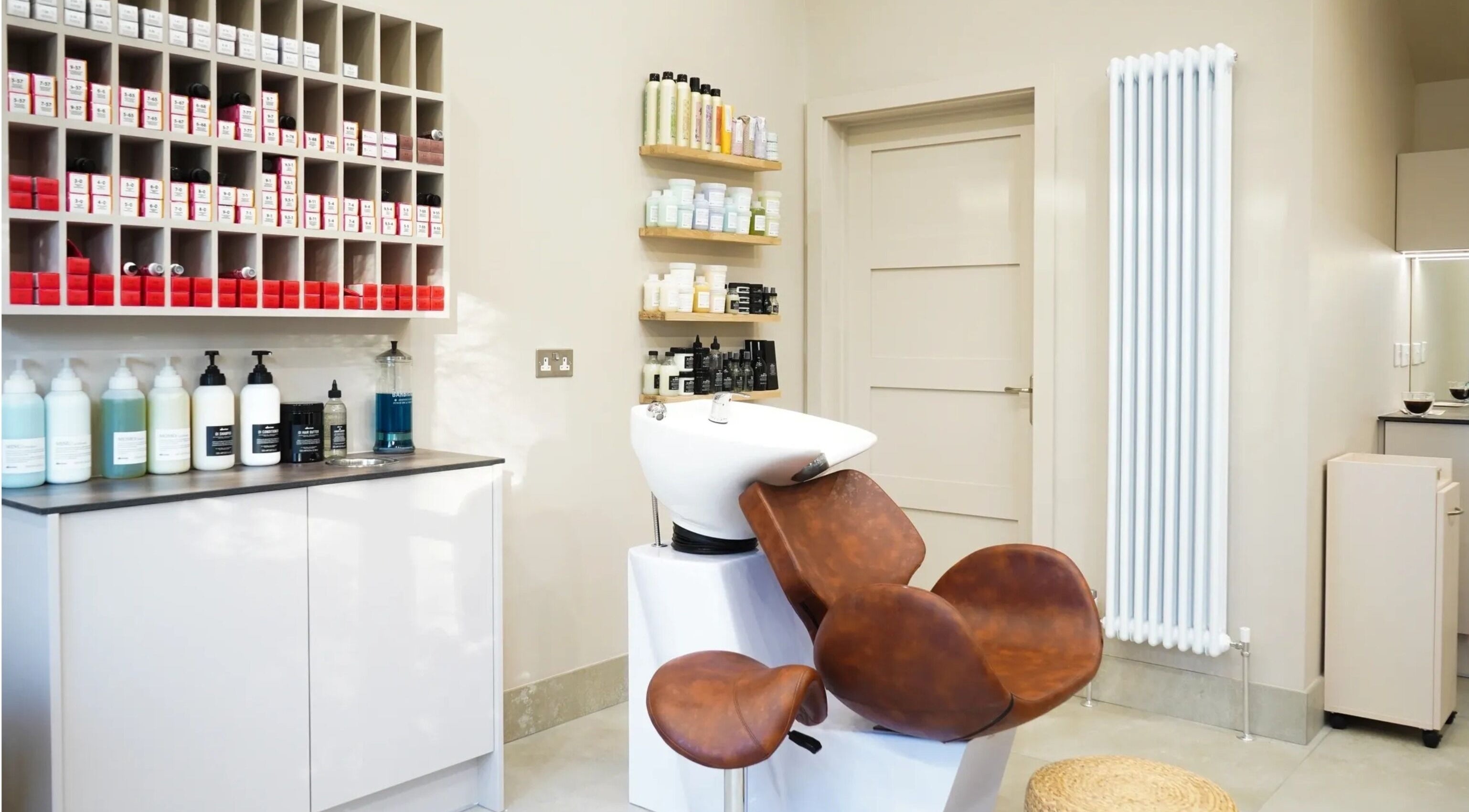 Grace Waker Hair salon interior in Oakley, England, GB features a stylish wash station with products.