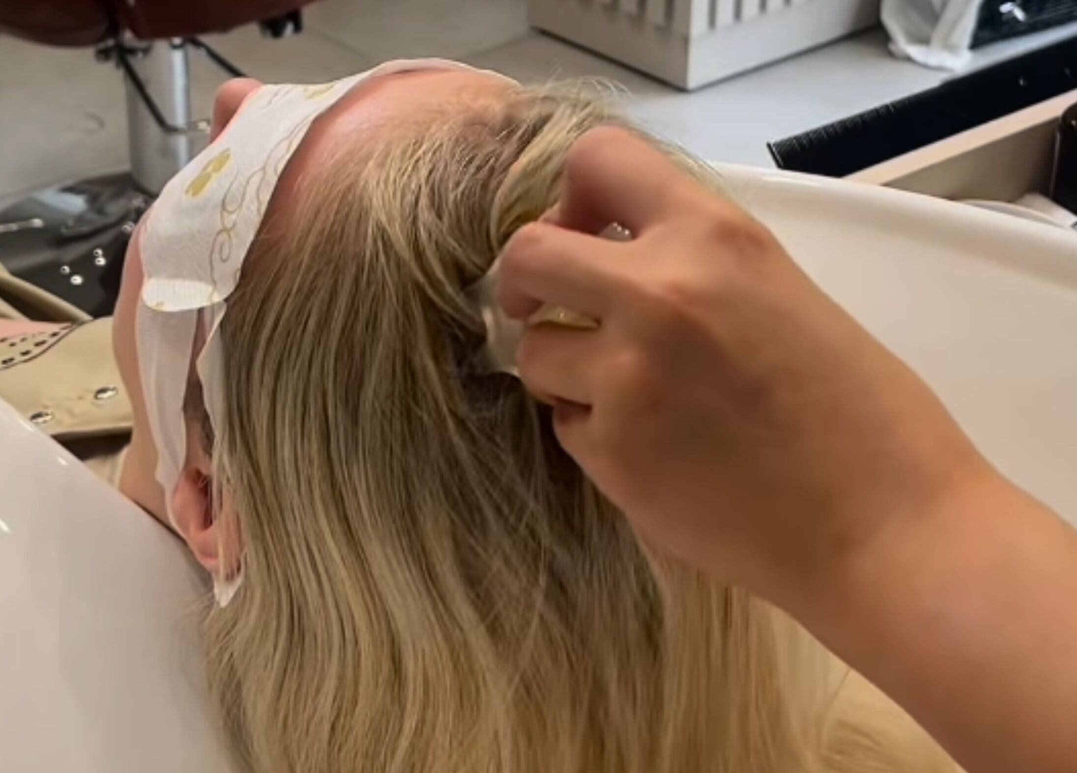 Client enjoying a soothing scalp massage at Grace Waker Hair, Oakley, England, GB.
