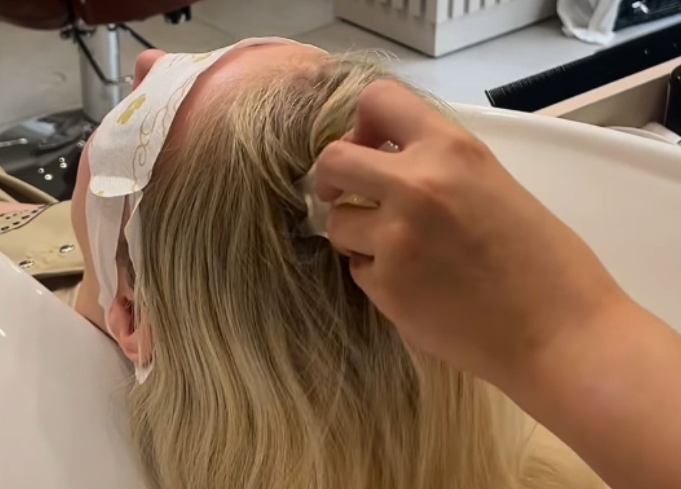 Client enjoying a soothing scalp massage at Grace Waker Hair, Oakley, England, GB.