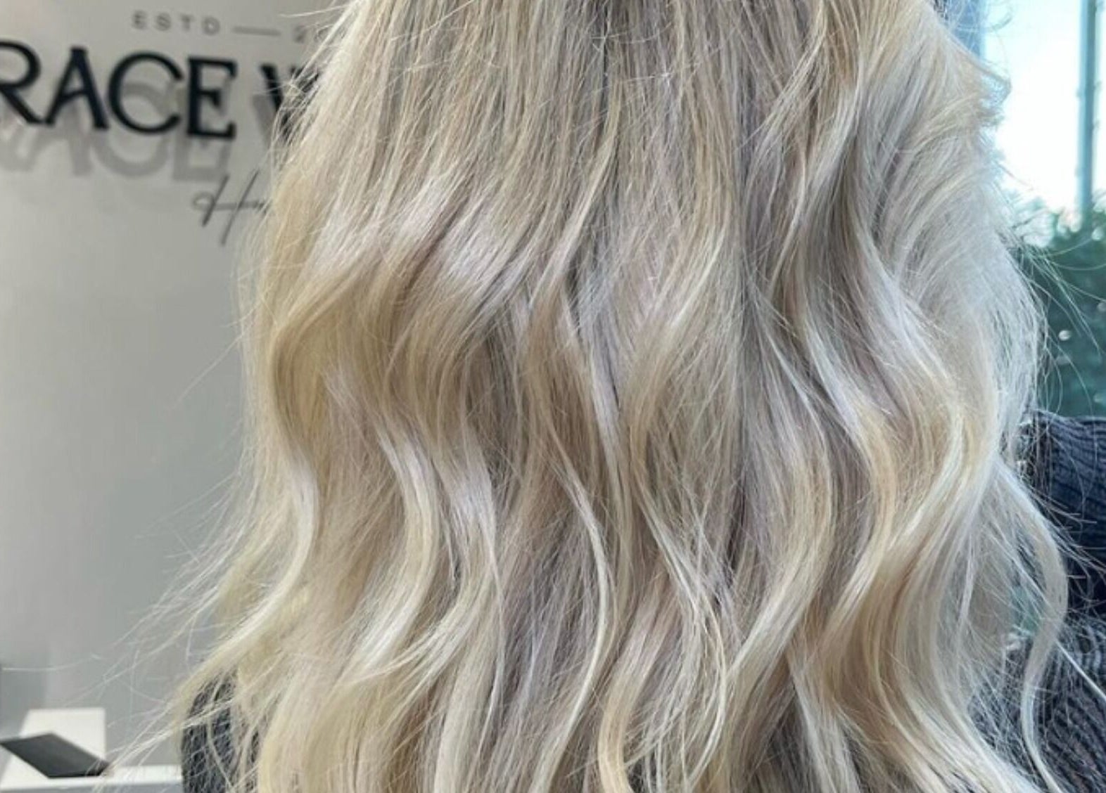 Elegant blonde waves styled at Grace Waker Hair, Oakley, England, GB, highlighting professional hairstyling services.