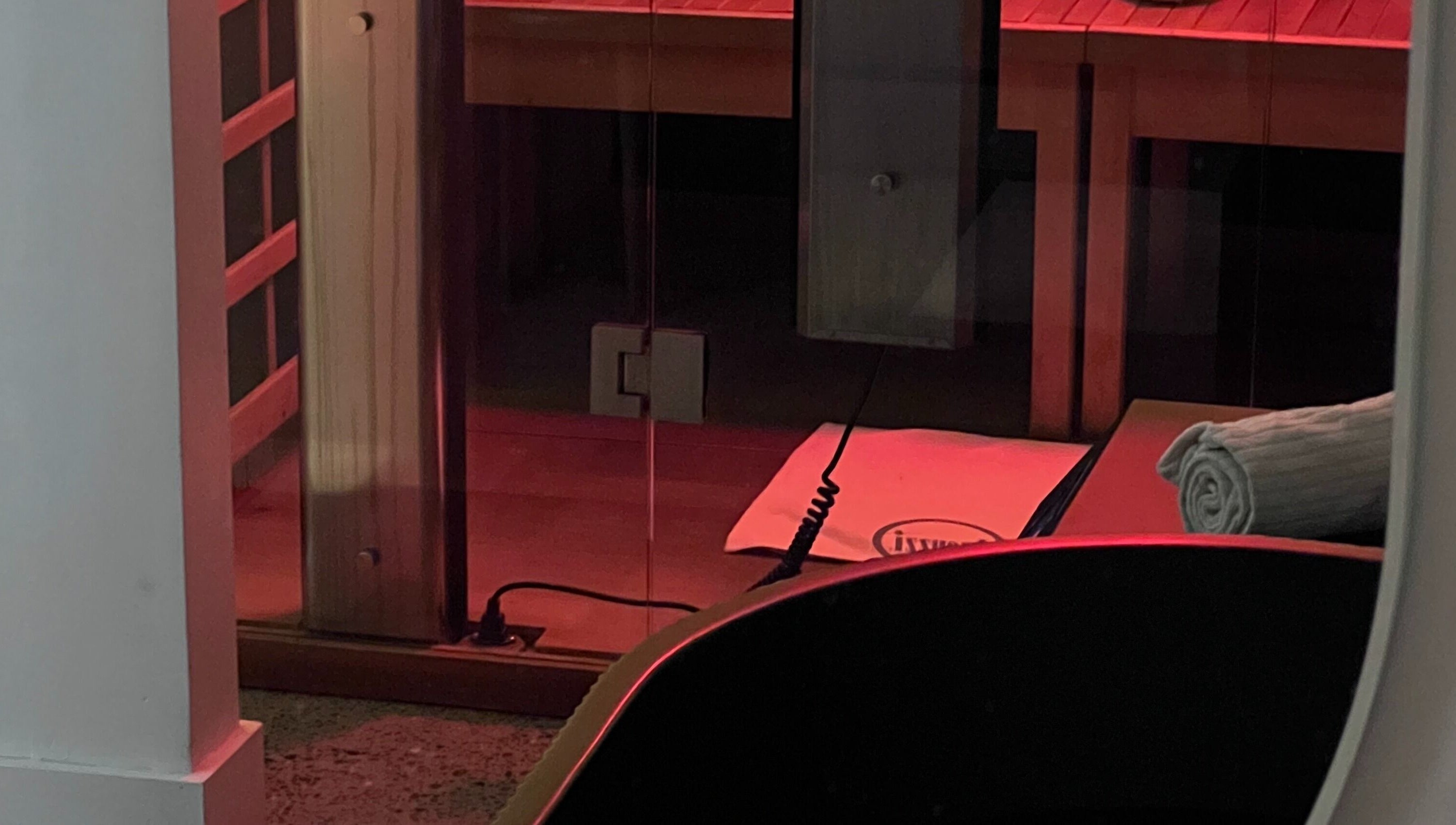 Relaxing infrared sauna room at Nimbus Co Manly, Manly, New South Wales, AU with warm red lighting.