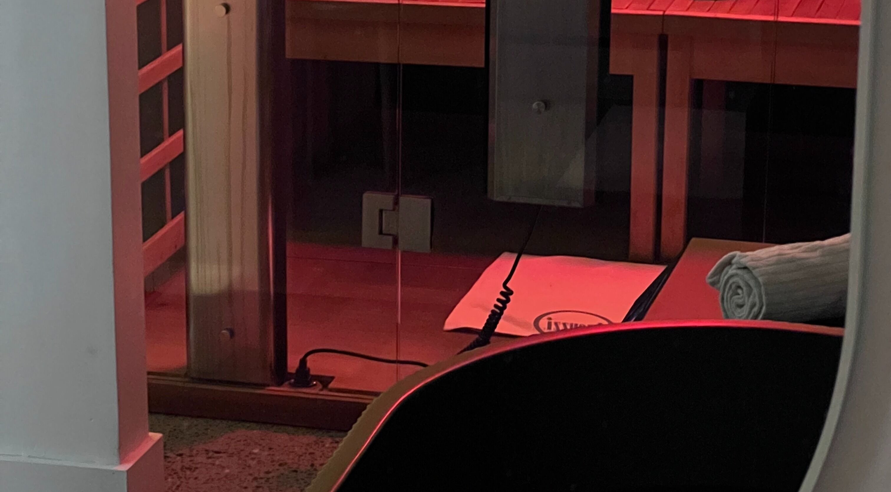 Relaxing infrared sauna room at Nimbus Co Manly, Manly, New South Wales, AU with warm red lighting.