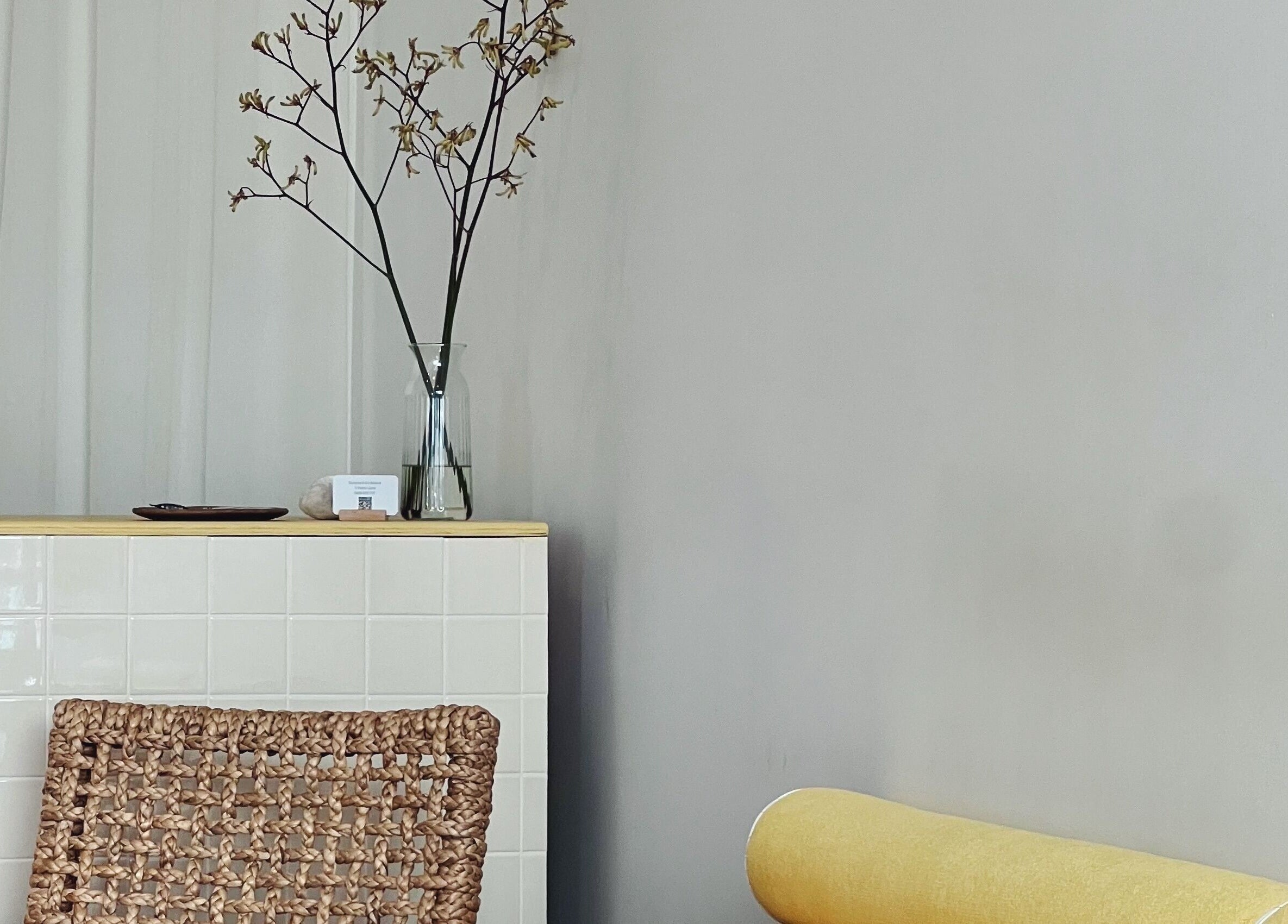 Stylish interior with woven chair and floral decor at Nimbus Co Manly, Manly, New South Wales, AU.