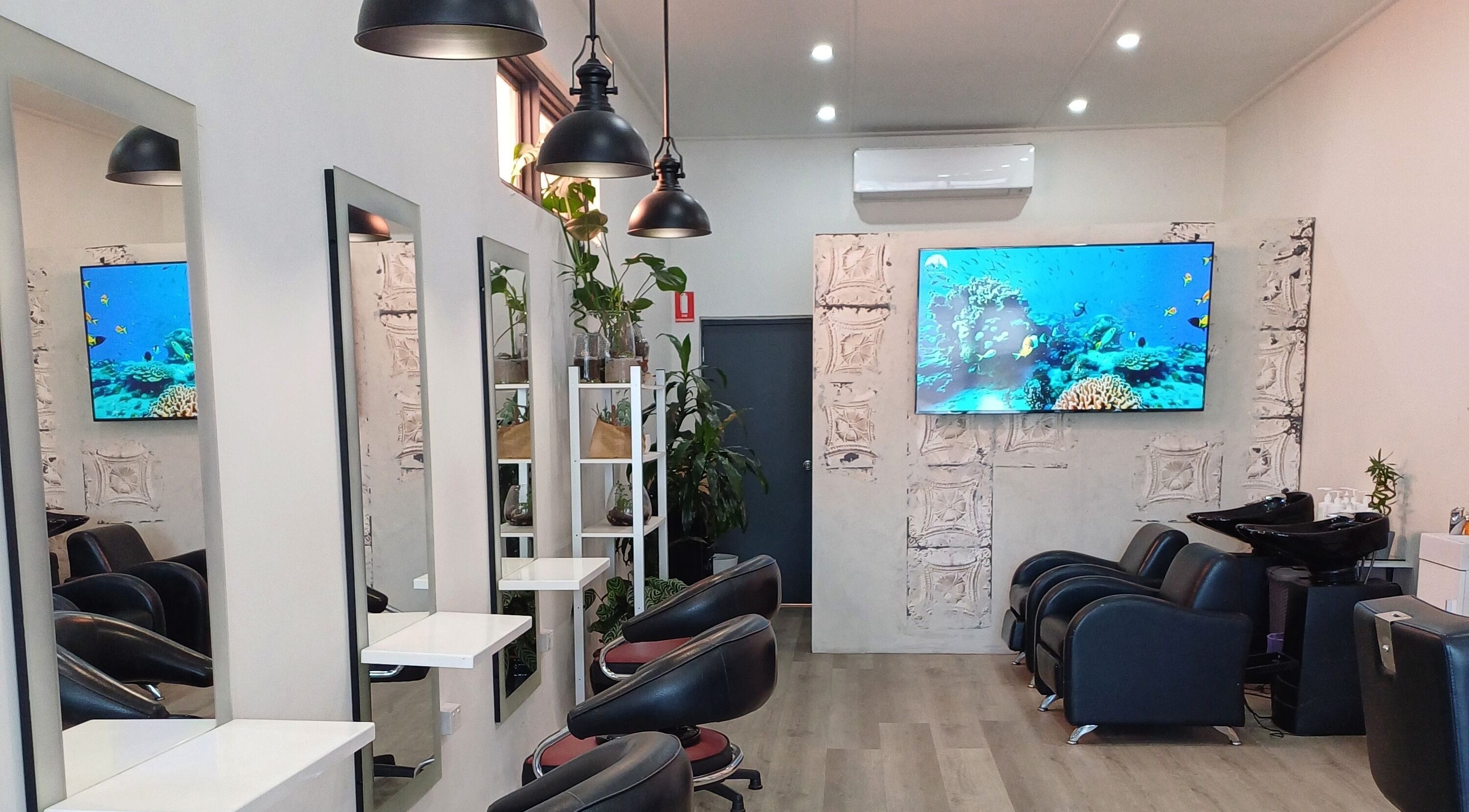 Modern interior of Unseen Hair Salon in Melbourne, Victoria, AU, featuring sleek chairs and luxury decor.