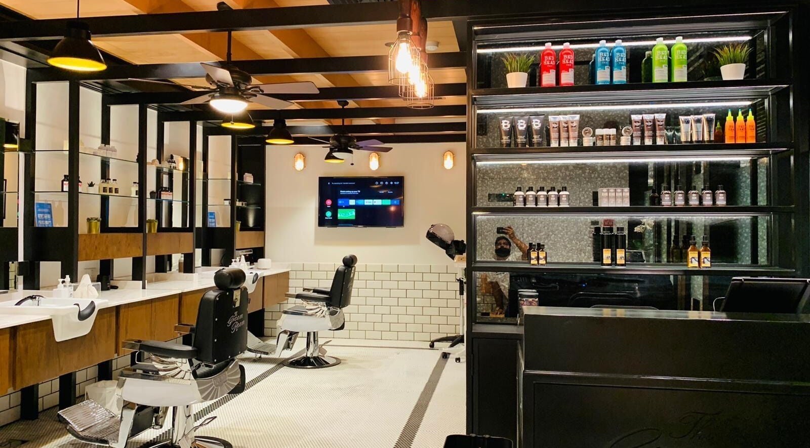 The Groom Room | Dilmunia, a stylish barber setting on Dilmunia Island, BH, features sleek chairs and product displays.