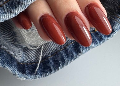 Elegant maroon nails manicured at LS Nails and Training, Carrigtowhill, County Cork, IE, showcased on denim fabric.
