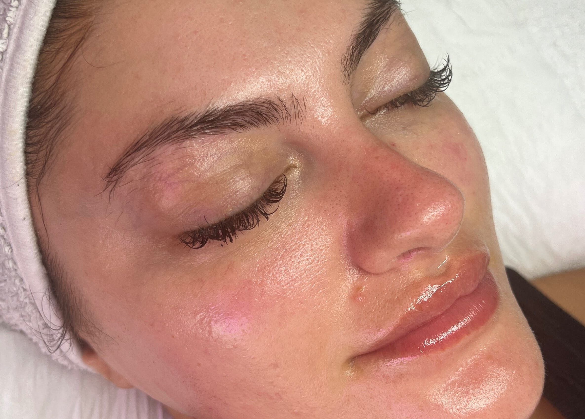 Relaxed woman after treatment at The Facial Bar, North London, England, GB with glowing, refreshed skin.