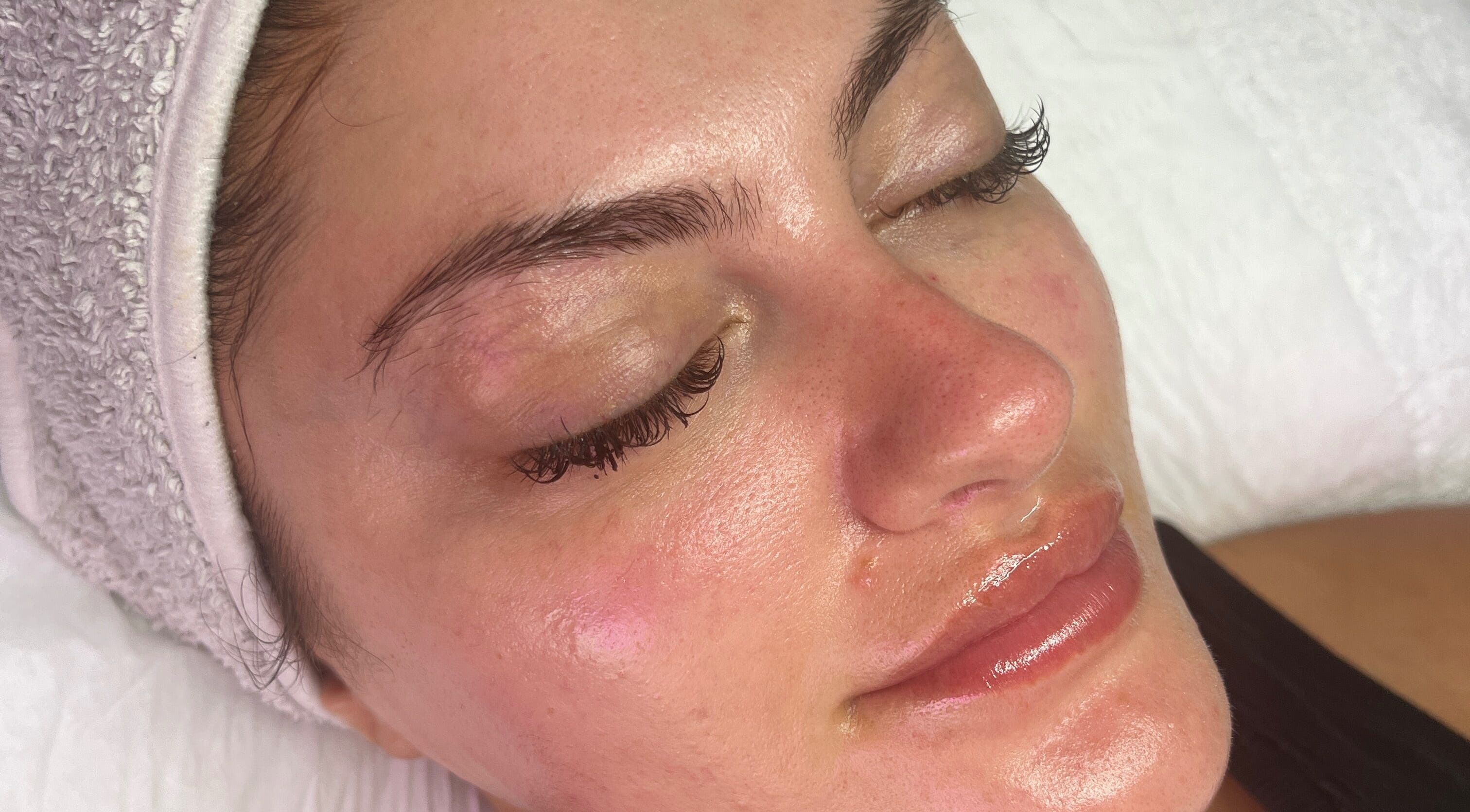 Relaxed woman after treatment at The Facial Bar, North London, England, GB with glowing, refreshed skin.