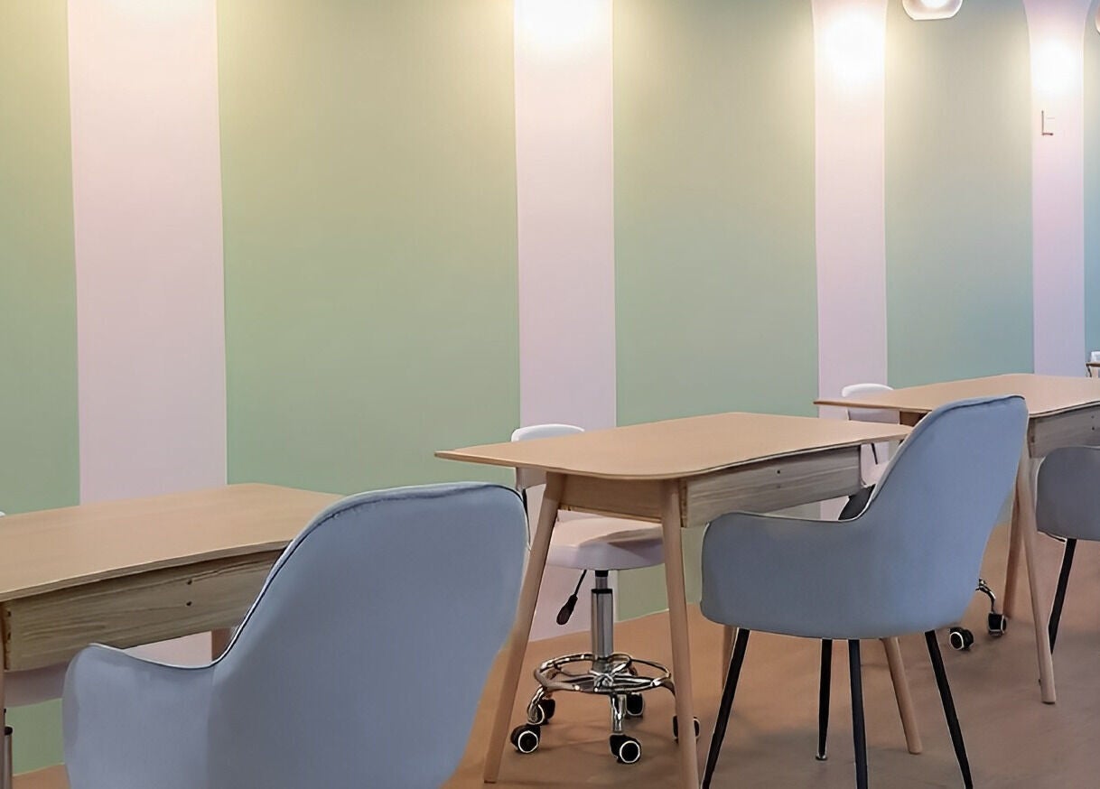 Modern manicure tables at Manikyu in CHERAS, KUALA LUMPUR, MY with comfortable seating and soft lighting.