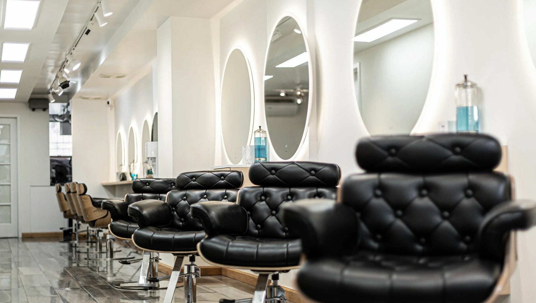 Elegant salon interior with black chairs at Decode Salon Flushing, New York, New York, US.
