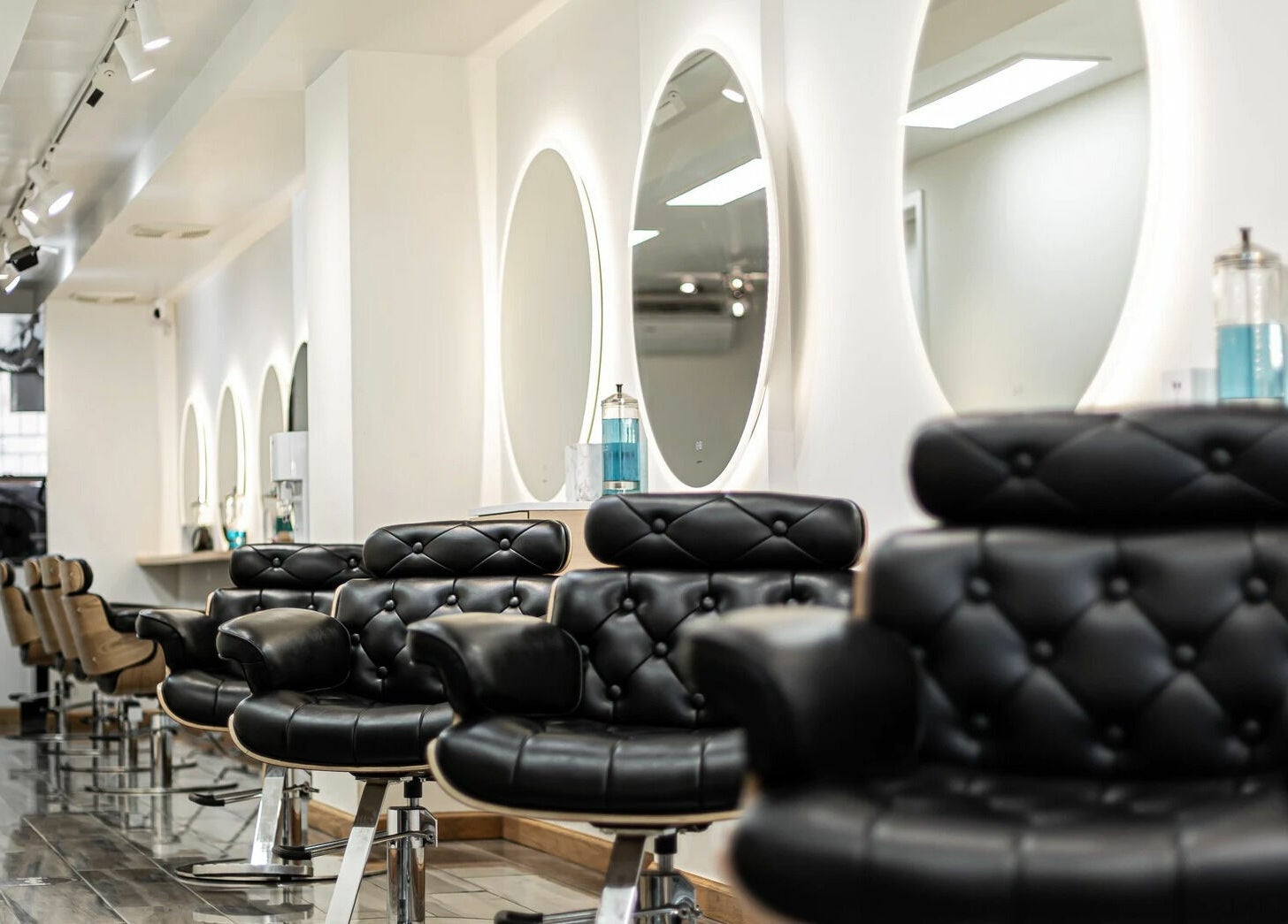 Elegant salon interior with black chairs at Decode Salon Flushing, New York, New York, US.