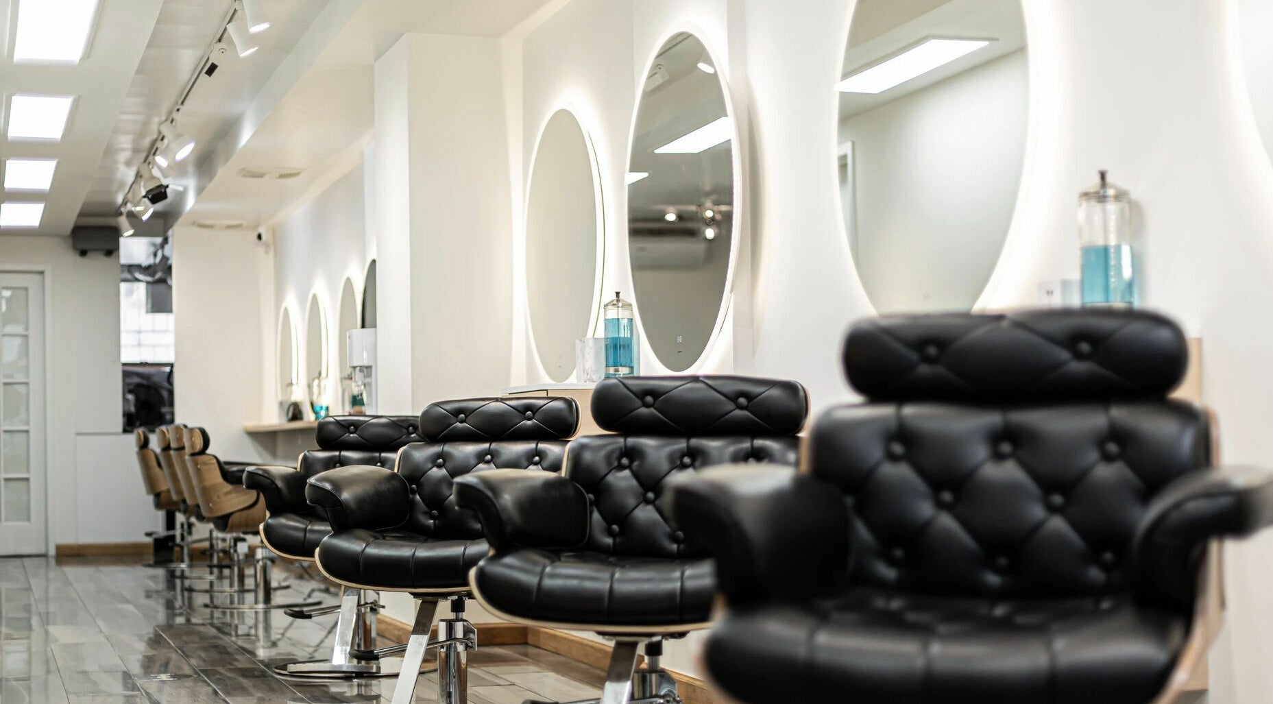 Elegant salon interior with black chairs at Decode Salon Flushing, New York, New York, US.