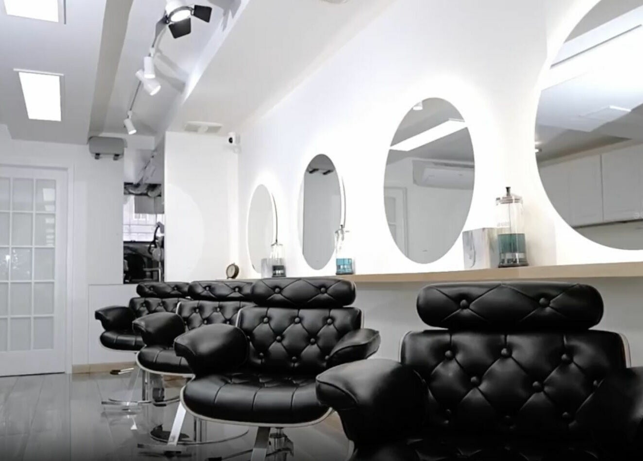 Modern black salon chairs and mirrors at Decode Salon Flushing, New York, New York, US.