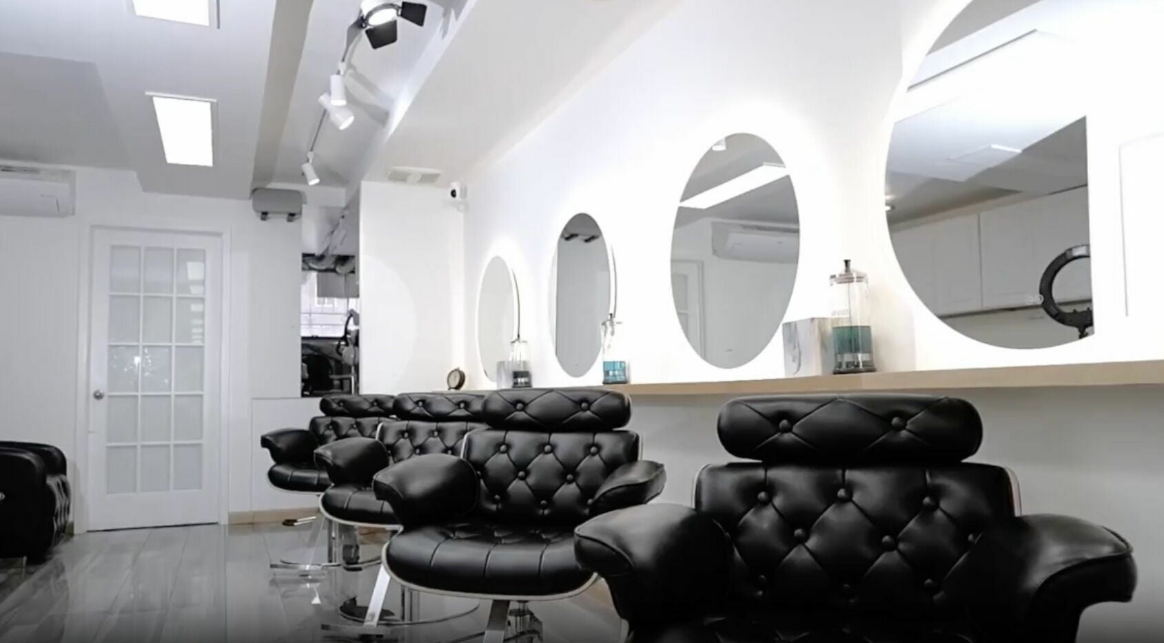 Modern black salon chairs and mirrors at Decode Salon Flushing, New York, New York, US.