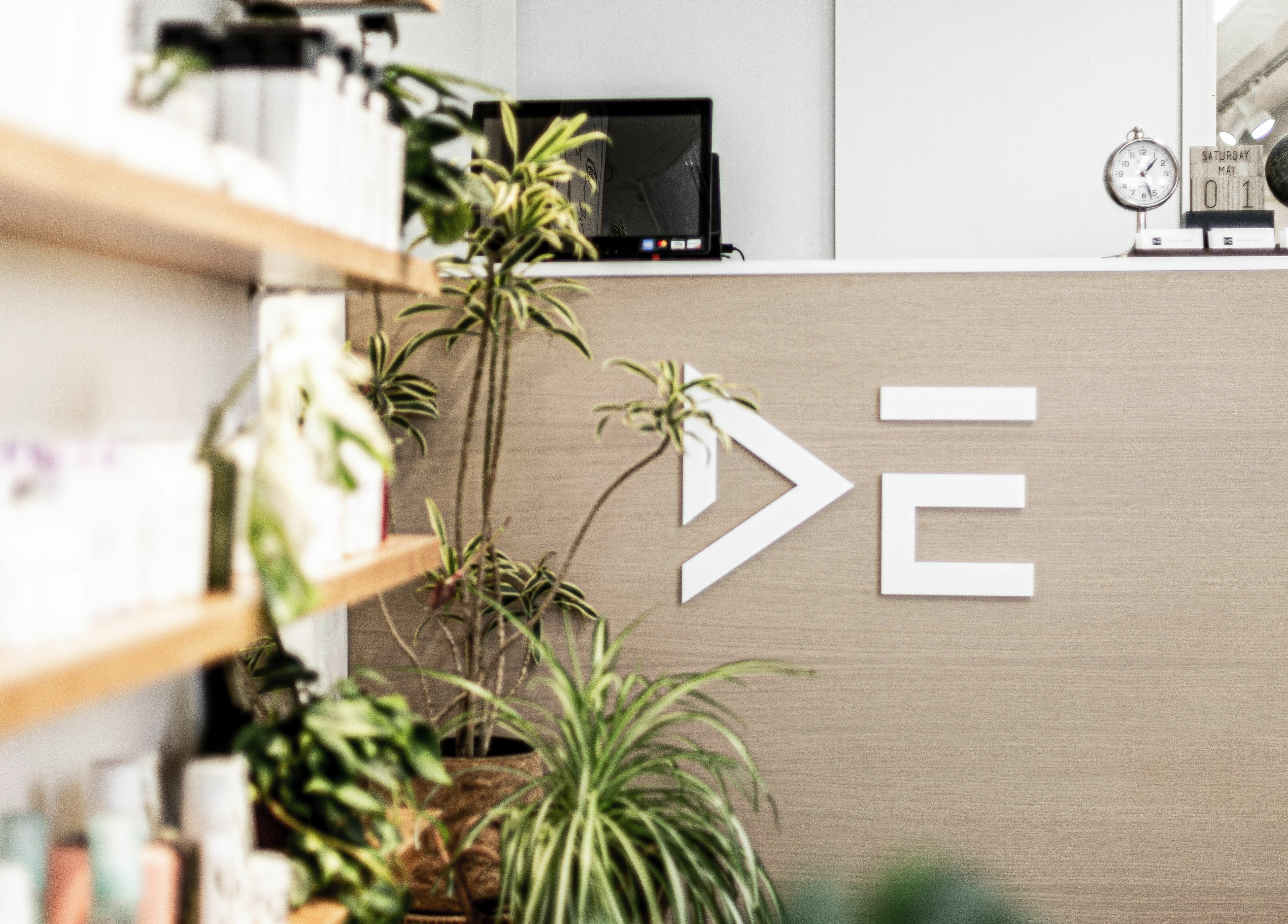 Chic reception area at Decode Salon Flushing, New York, New York, US adorned with plants and sleek decor.