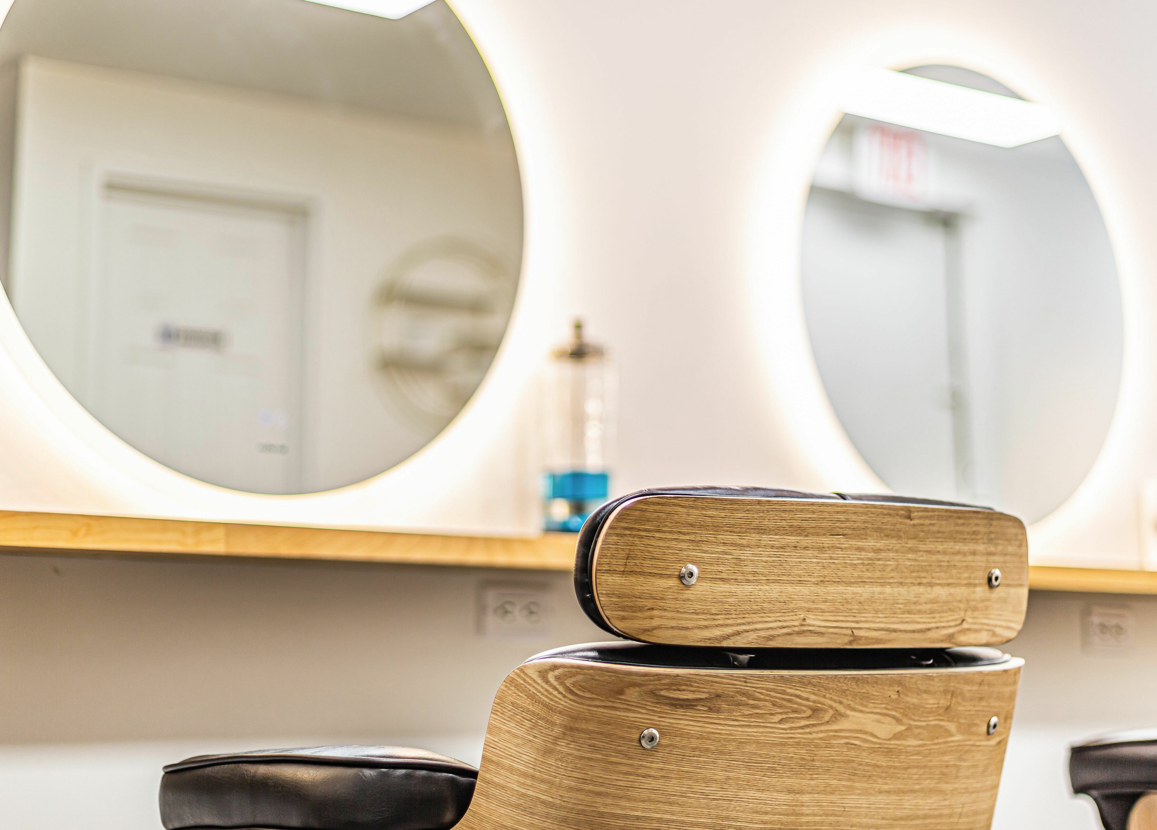Modern salon chair and mirror at Decode Salon Flushing, New York, New York, US showcasing elegance.