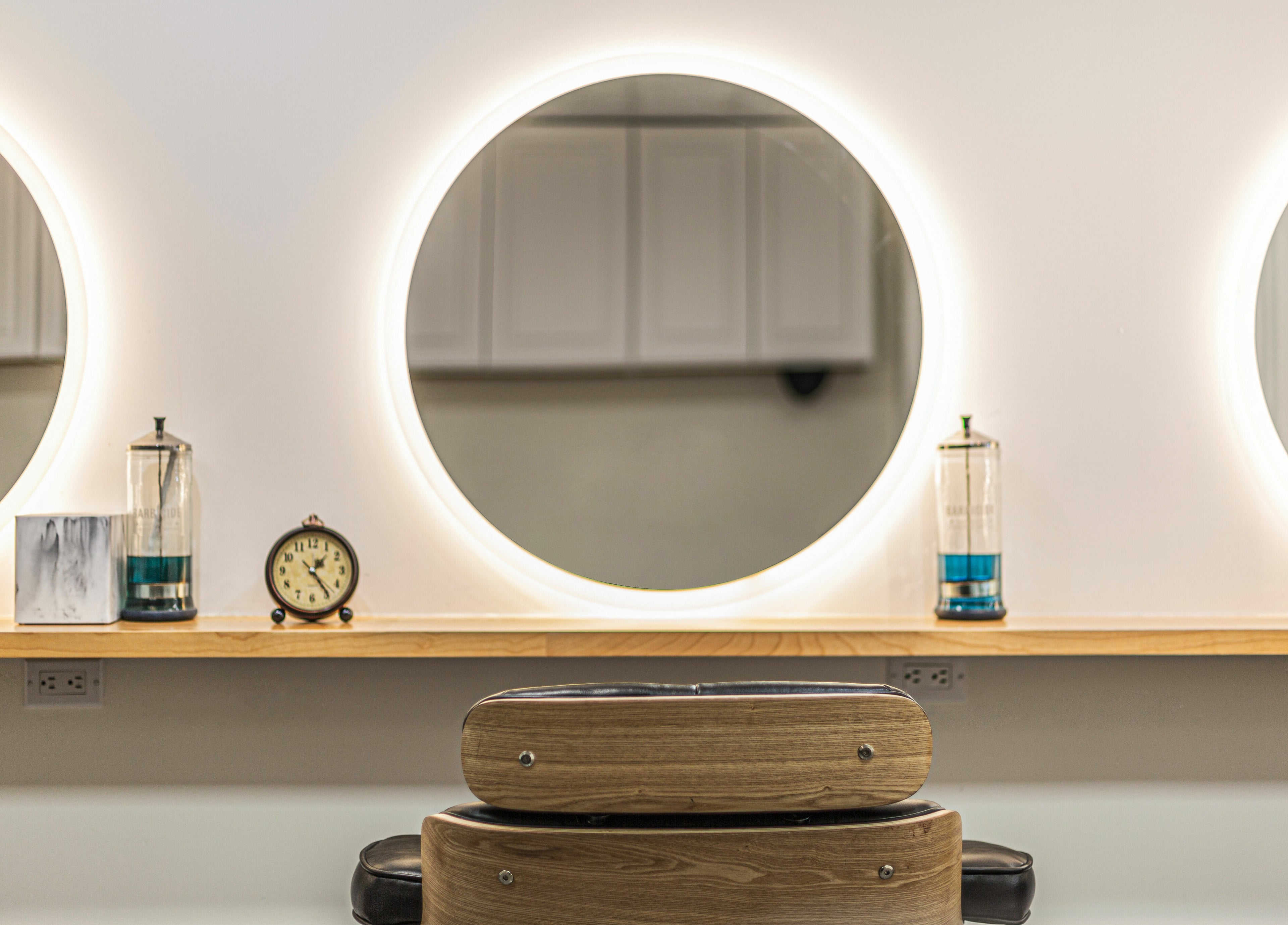 Chic styling station with round mirrors at Decode Salon Flushing, New York, New York, US.