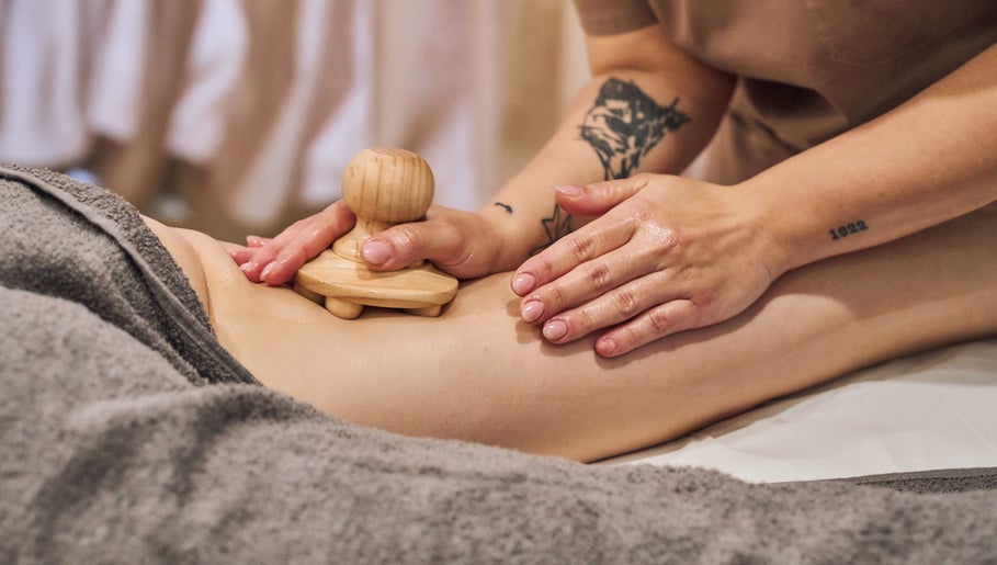 Massage therapy at Fina, B kara, MT, promotes relaxation with wooden massager technique.